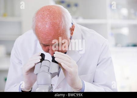 Male scientist using microscope in laboratory Stock Photo