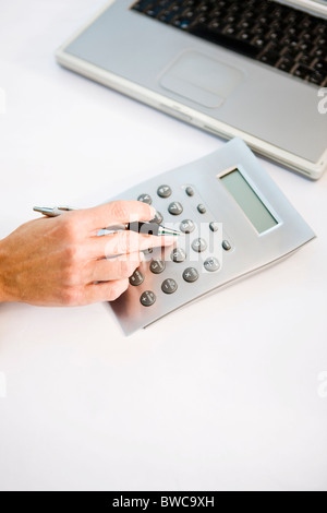 Businessman using calculator, elevated view Stock Photo