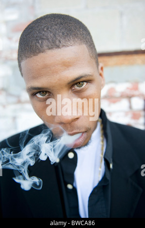 USA, Illinois, Peoria, Portrait of young man smoking Stock Photo