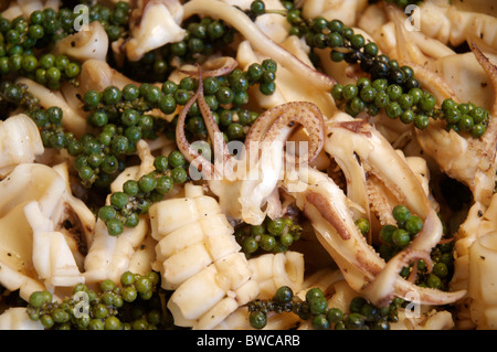 A Cambodian meal of stir fried squid and green peppercorns. Stock Photo