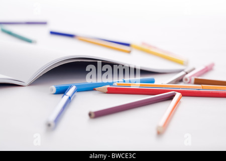 Image of colorful pencils and highlighters with open drawing album near by Stock Photo