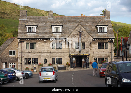 Driving through Corfe Castle village past the Bankes Arms Hotel and restaurant, Corfe Castle, Dorset UK in September Stock Photo