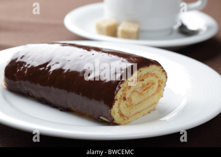 Swiss roll with cream filling and chocolate topping Stock Photo