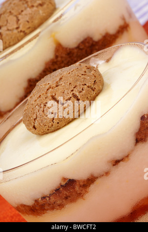 Close-up of vanilla custard and amaretto dessert served in glass cups. Selective focus. Stock Photo