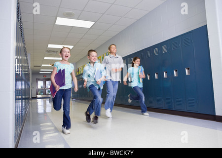 USA, Illinois, Metamora, Children (8-9, 10-11) running through school corridor Stock Photo