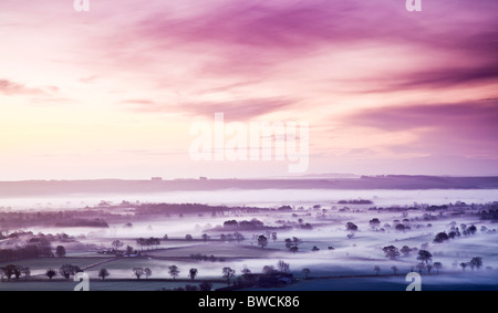 Misty autumn sunrise from Knapp Hill over the Vale of Pewsey in Wiltshire, England, UK Stock Photo