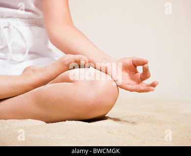 USA, Illinois, Metamora, Young woman doing yoga on beach Stock Photo