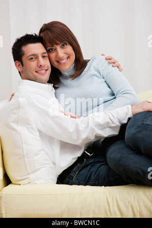 USA, Illinois, Metamora, Portrait of Couple embracing on sofa Stock Photo