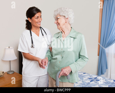 USA, Illinois, Metamora, Nurse helping senior woman with cane Stock Photo