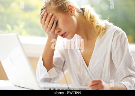 Woman stressed in office Stock Photo