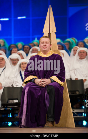 Chaired Bard Tudur Hallam on stage during a ceremony at the National Eisteddfod of Wales annual Welsh cultural festival Stock Photo