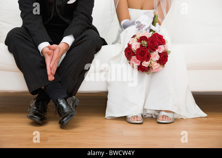 USA, Illinois, Metamora, Bride and groom sitting on sofa Stock Photo