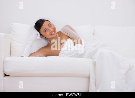 USA, Illinois, Metamora, Portrait of bride relaxing on sofa Stock Photo
