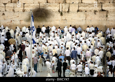 Jewish religious man with traditional clothes pray at the Wailing Wall in the old city of Jerusalem at Yom Kippur Stock Photo