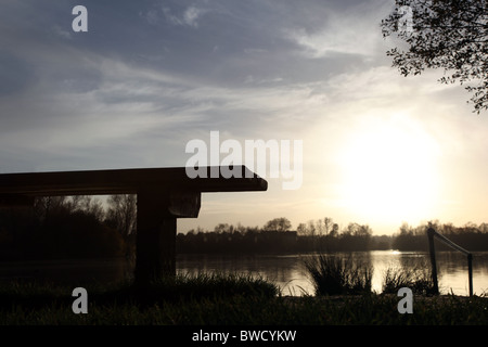 Empty bench overlooking a lake. Stock Photo
