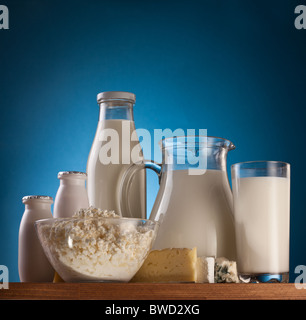 Different milk products: cheese, cream, milk, yoghurt. On a blue background. Stock Photo