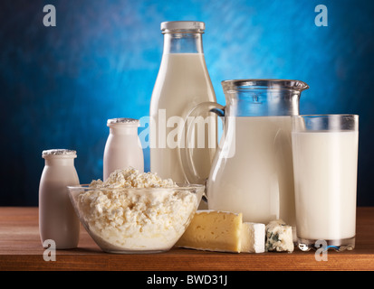 Different milk products: cheese, cream, milk, yoghurt. On a blue background. Stock Photo