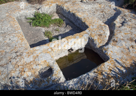 So-called rock cutouts called 'cart ruts' and dating to prehistory are found in several places on rocky plateaus in Malta. Stock Photo