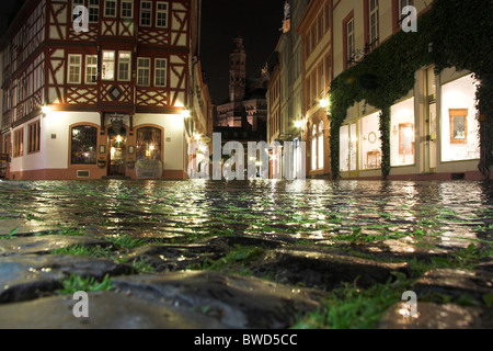 Low angle of a cobbled square, half-timbered house, Mainz at night, Germany Stock Photo