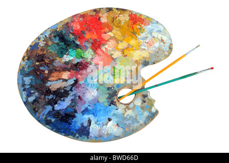 Artist's palette with paintbrushes isolated over white background - With clipping path Stock Photo