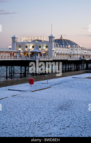 Brighton royal pier at dusk with snow on the beach JPH0276 Stock Photo