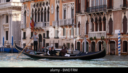 Tourists enjoy an outing on a gondola on the Grand Canal in Venice, Italy Stock Photo