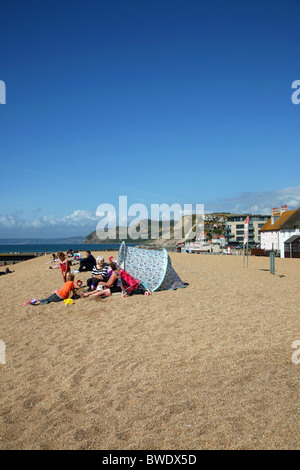 Enjoying a day on Chesil Beach at West Bay, a popular seaside resort near Bridport on West Dorset's Jurassic Coast Stock Photo