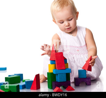 Beautiful baby building a castle with cubes isolated on white Stock Photo