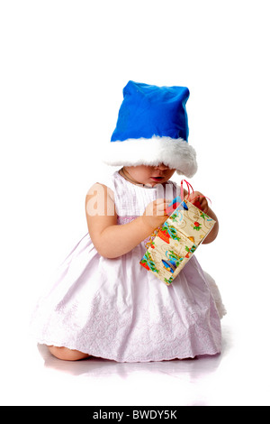 Beautiful baby in Santa's hat with a present isolated on white Stock Photo