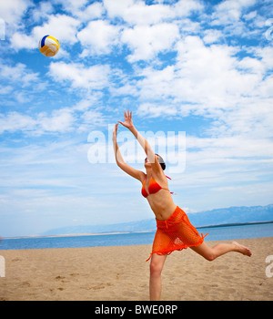 Woman playing volleyball at the beach Stock Photo