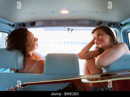 Women camping in back of car Stock Photo