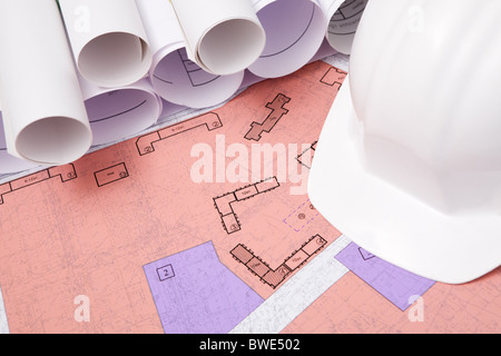 Close-up of blueprints and helmet on workplace Stock Photo