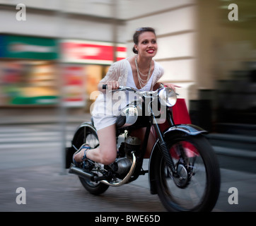 Young woman riding motorcycle Stock Photo