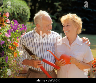 Retired Senior Couple in home garden Stock Photo