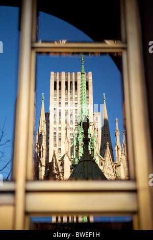 Copper Christ statue on top of St Patrick's Cathedral, The Rockefeller Center in Background. Stock Photo