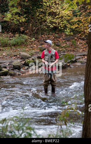 Fishing for trout in Irondequoit Creek Penfield NY USA Stock Photo