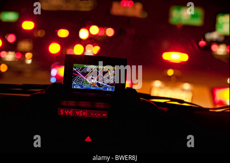 GPS unit in the window of a car in traffic. Stock Photo