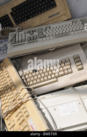 A pile of old unused keyboards at a bring in site for waste separation. Stock Photo