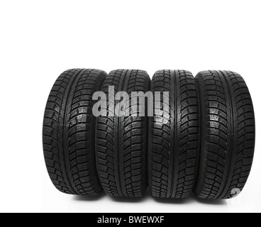 Set of four winter tires isolated on white background Stock Photo