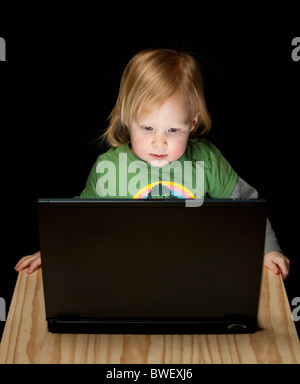 Little girl working on laptop, Germany Stock Photo