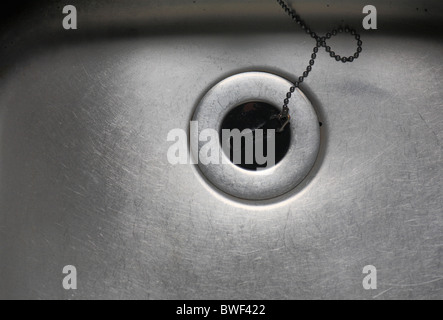 Stainless steel kitchen sink with the plug in. Stock Photo