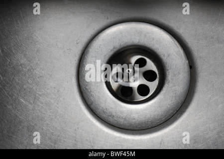 Water disappearing down the plug hole in a sink.