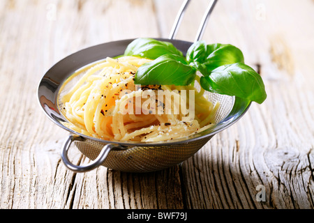 Spaghetti sprinkled with parmesan and vegetable seasoning Stock Photo