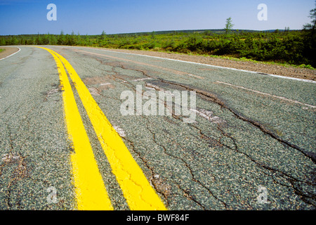 Empty paved road with yellow double line Stock Photo