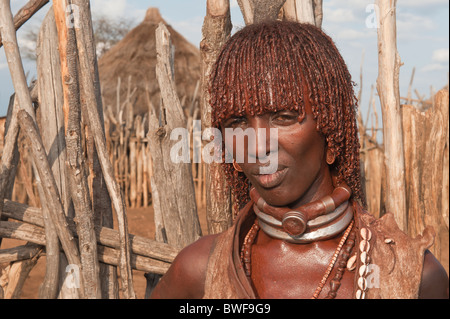 Young Hamar woman with red clay in her hair and wearing a goat dress, Omo river valley, Southern Ethiopia Stock Photo