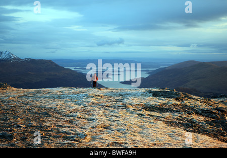 View of Loch Lomond with the tip of Ben Lomond with a smattering of snow on the left hand side, from the slopes of Ben Vorlich Stock Photo
