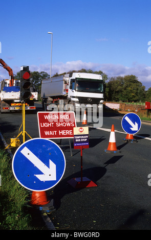 lorry passing through roadworks by temporary bus stop on road near leeds yorkshire uk Stock Photo