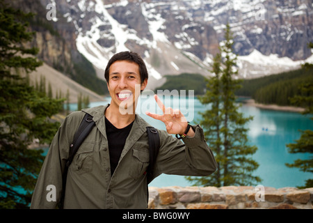 A portrait of a happy tourist in front of a scenic landscape Stock Photo