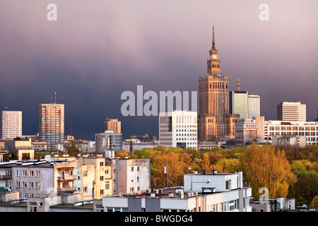 Warsaw, capital city of Poland, featuring Palace of Culture and Science, Srodmiescie district. Sunset time, stormy sky. Stock Photo