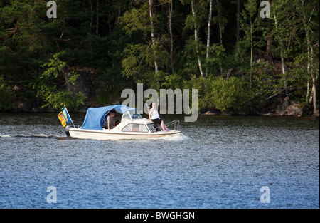 Overloaded boat with passengers.Lake Nashulta,Sweden Stock Photo